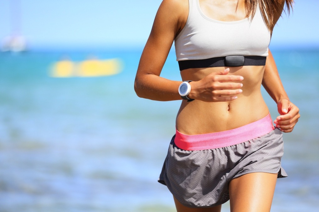 Bigstock-21109267-Runner-woman-with-heart-rate-monitor-running-on-beach-with-watch-and-sports-bra-top