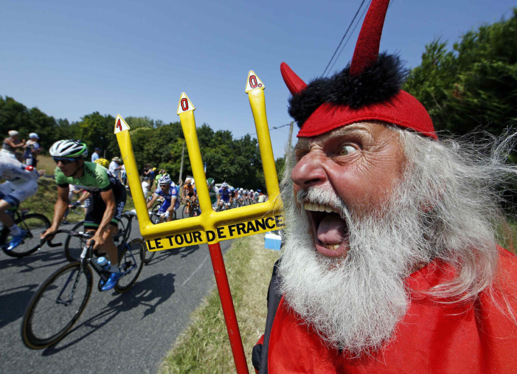 The pack of riders makes its way past Didi Senft, a cycling enthusiast better known as 'El Diablo' (The Devil), during the twelfth 218km stage of the centenary Tour de France cycling race from Fougeres to Tours. (Eric Gaillard/Reuters)